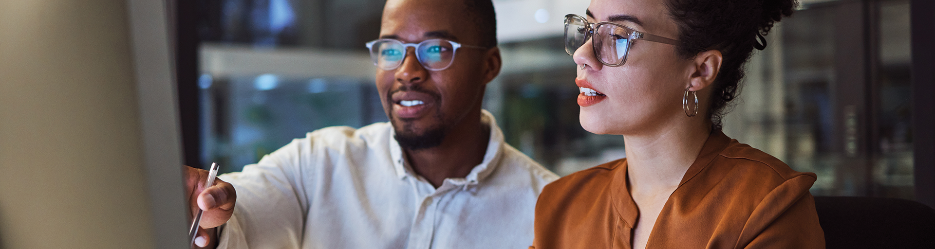 a man and a woman is looking at the computer