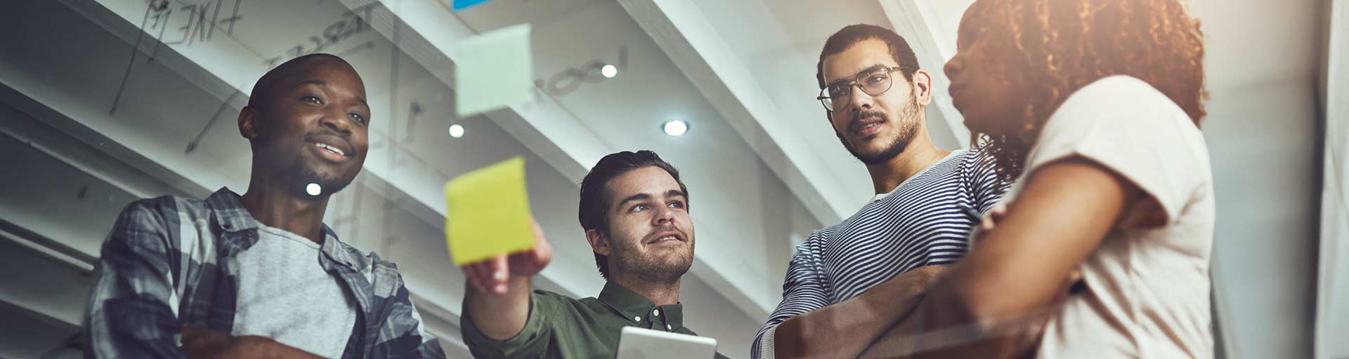 man smiling looking down at computer