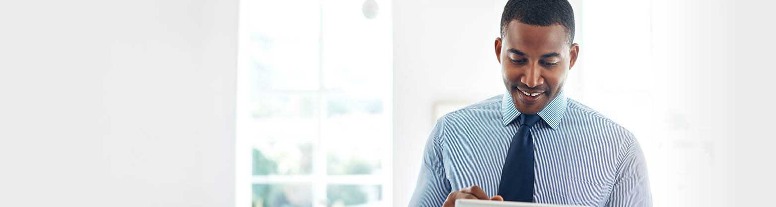 man smiling looking down at computer