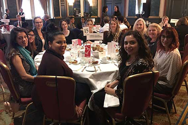 Students sitting around a dinner table