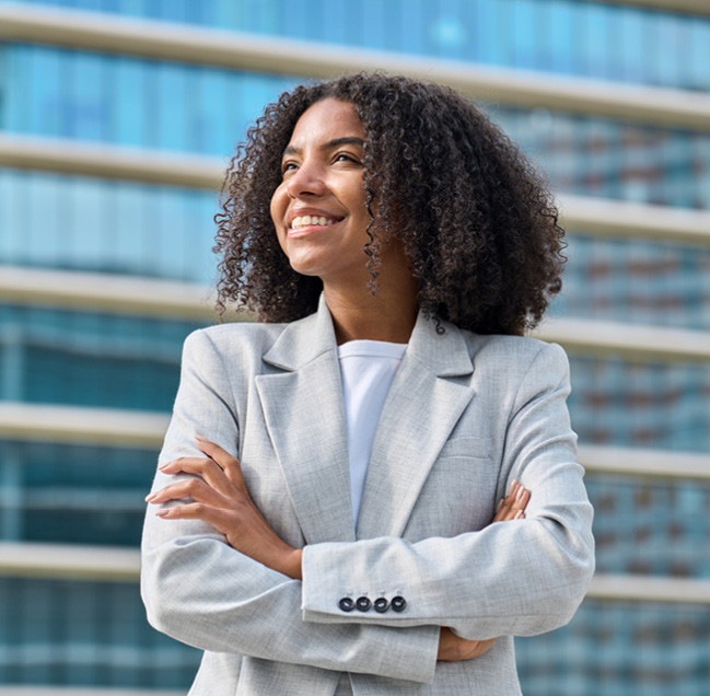 professional business person smiling with their arms crossed