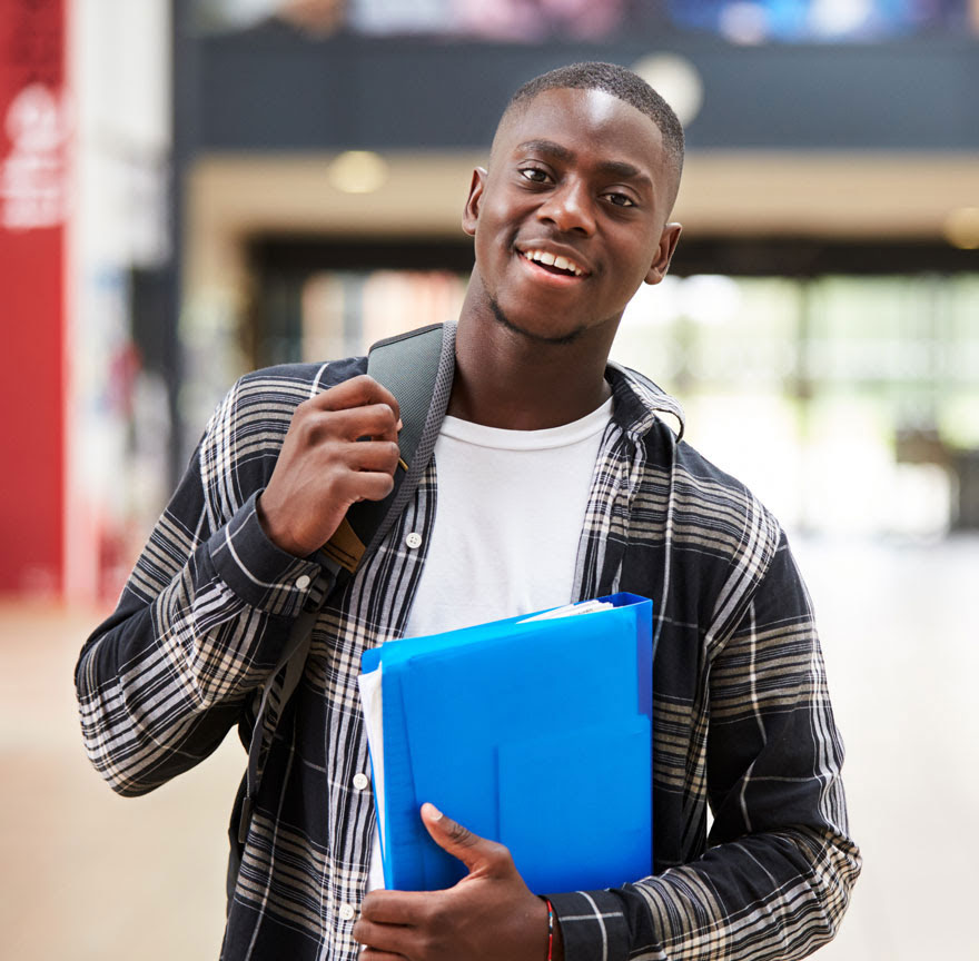 person holding a binder and smiling