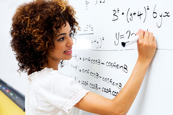 woman writing on a white board