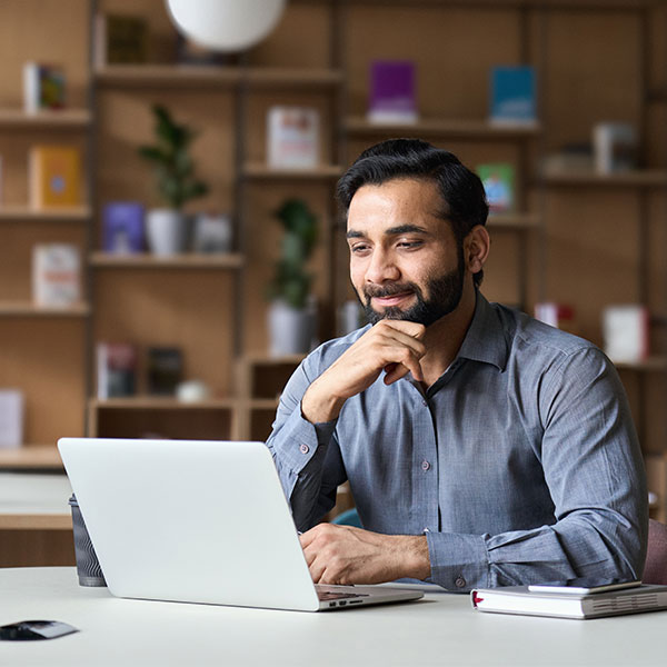 person sitting looking at laptop