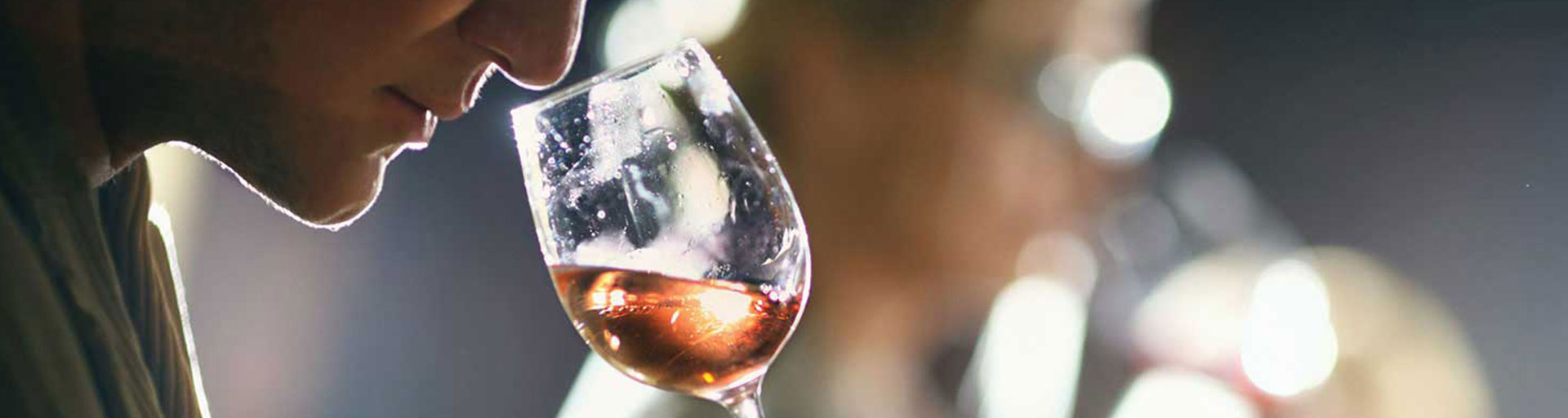 male sniffing a glass of wine