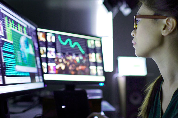 Person looking at computer monitors