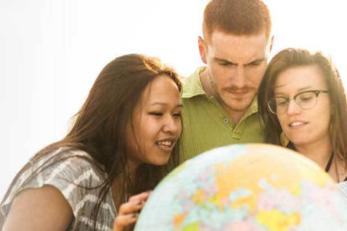Group of people looking at a globe