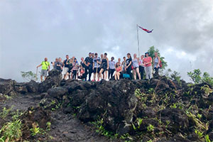 students standing on top of mountain
