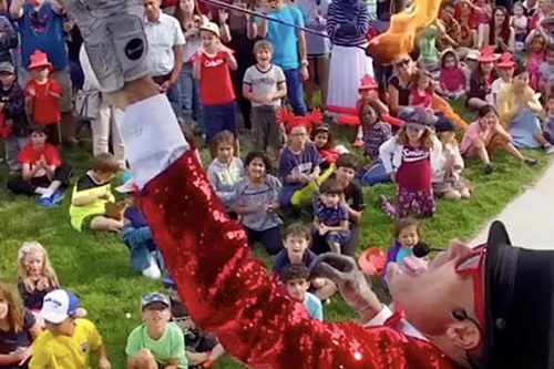 Person performing to a group of children