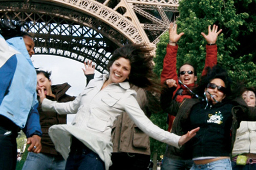 Group of students jumping in front of the Eiffel Tower