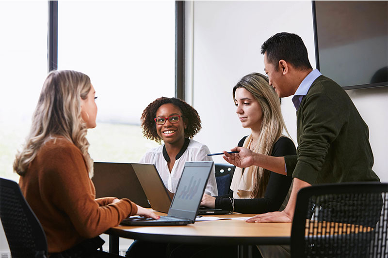 group of people sitting at a table talking