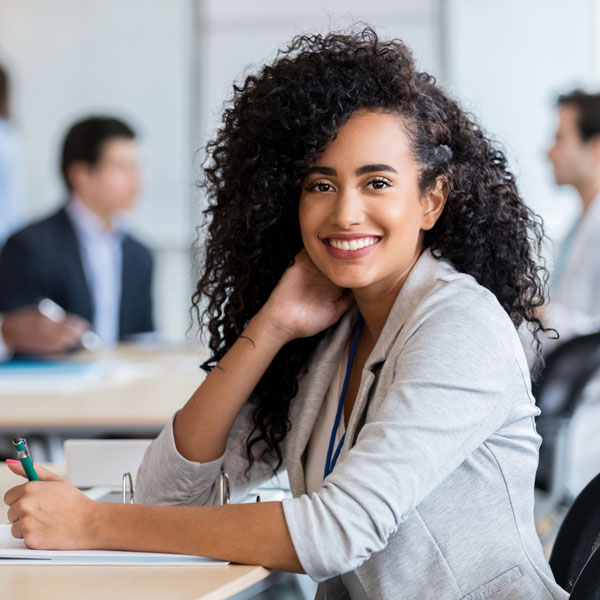 person sitting at a table smiling