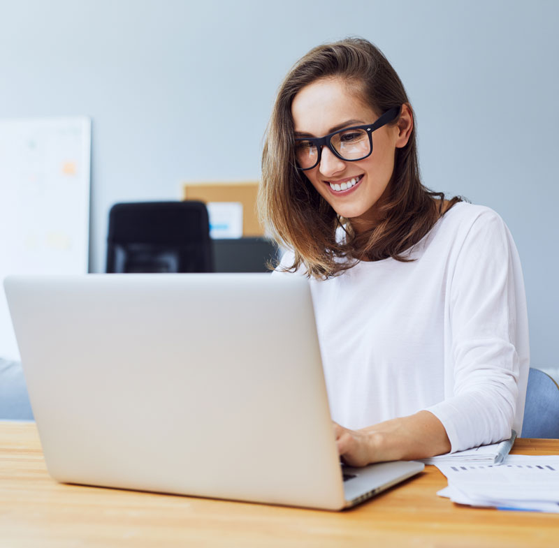 Person smiling working on laptop