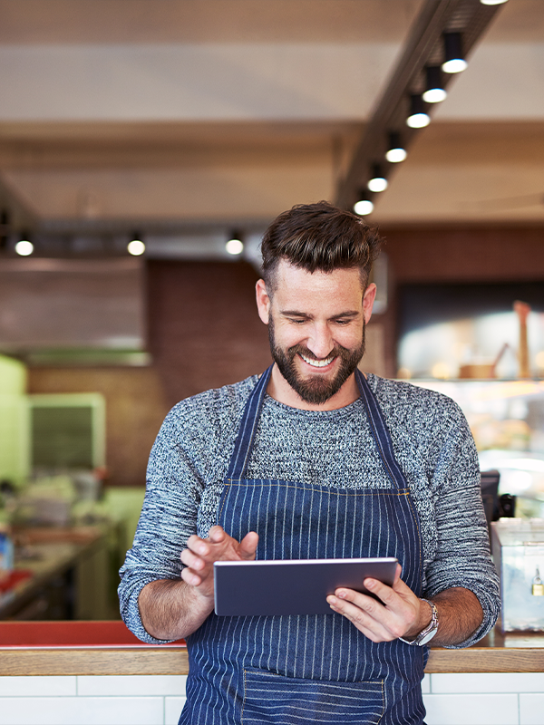 Person smiling looking at tablet