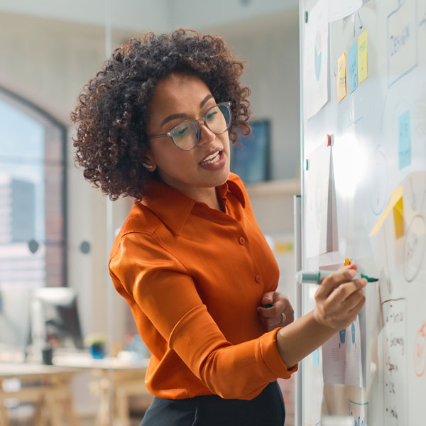 person writing on a whiteboard