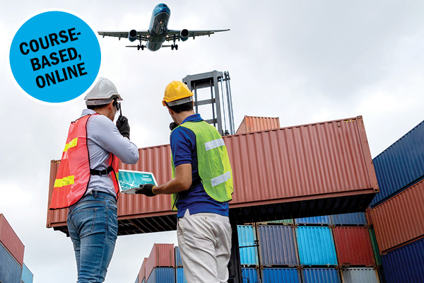 two people in front of cargo containers watching an airplane