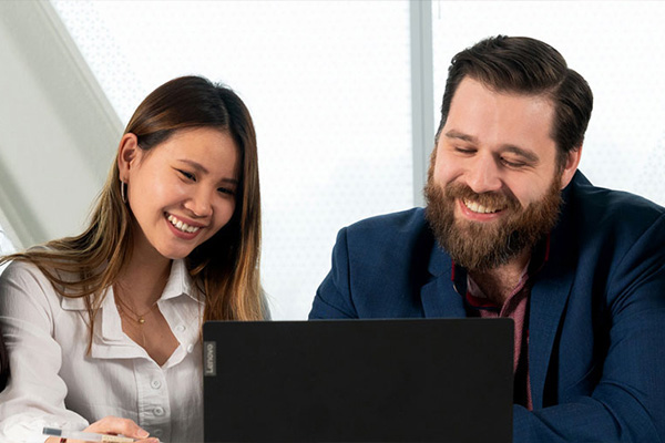 People smiling looking at laptop