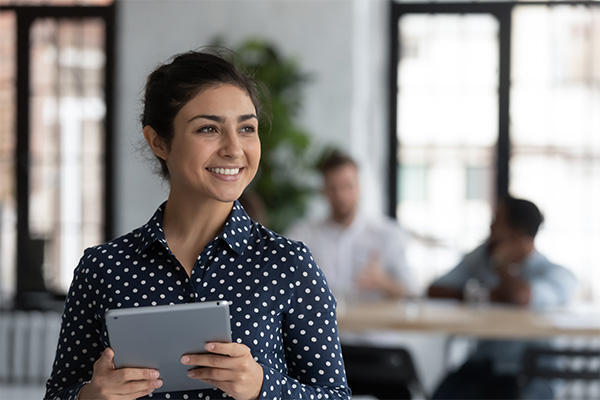 Smiling person holding tablet