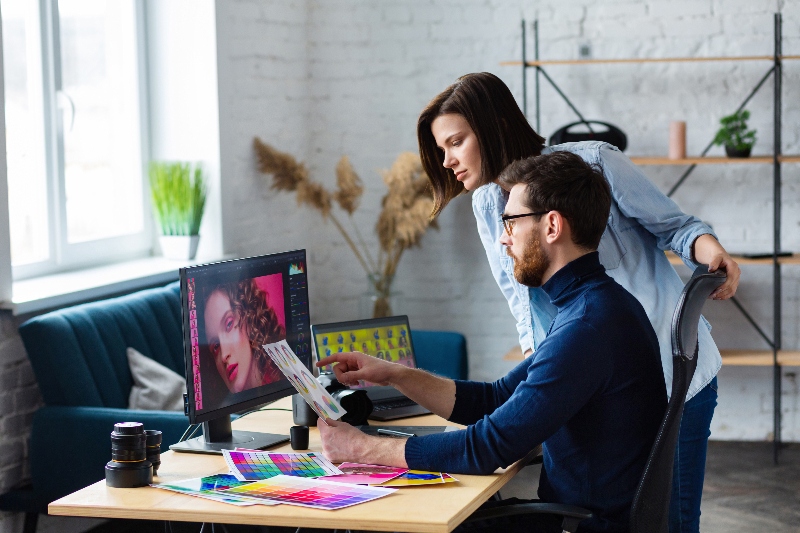 Two people in an office looking at a computer screen