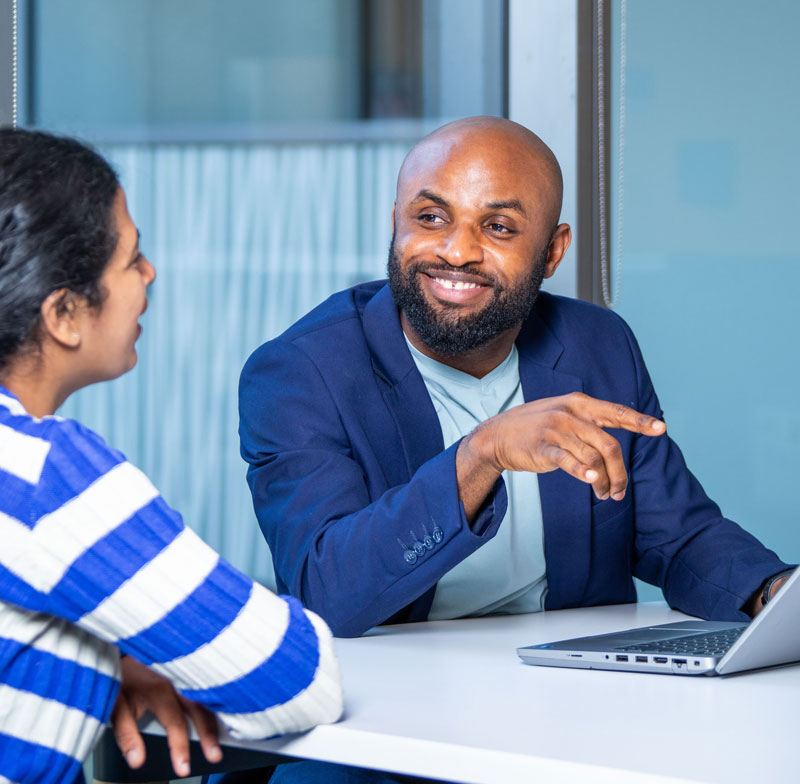 Person in suit talking to another