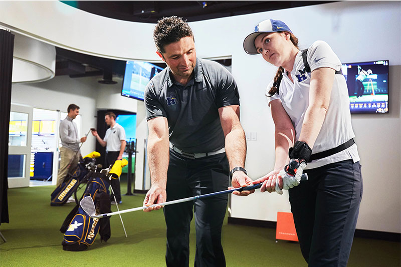 two people in a golf lab