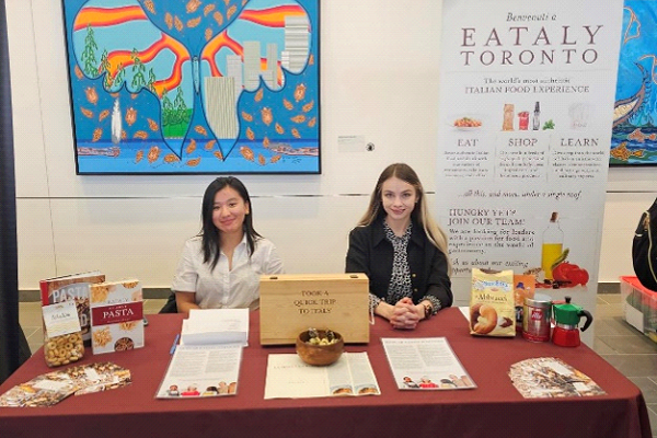 Eataly booth at event with two people sitting