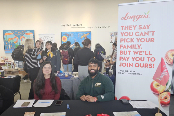 Longos booth at event with two people sitting down