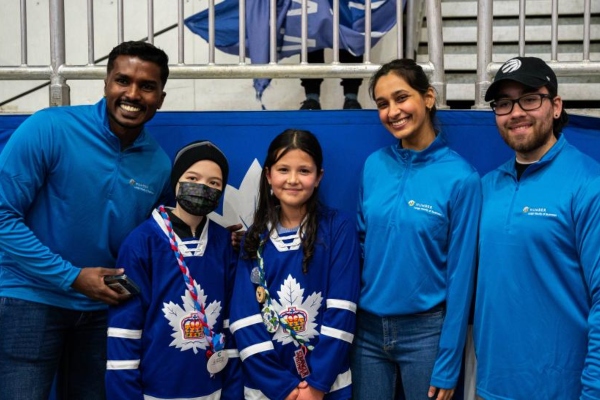 Campfire Circle children posing for a photo with Humber students at the Toronto Marlies game 