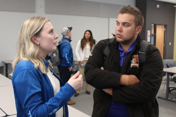 Canada Games staff member speaking one-on-one with a student