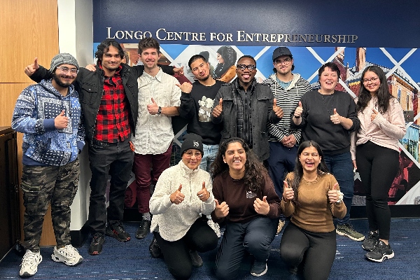 Business students smiling for a group photo