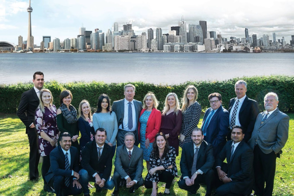 Accurate Appraisals team standing in front of the Toronto skyline for a group photo