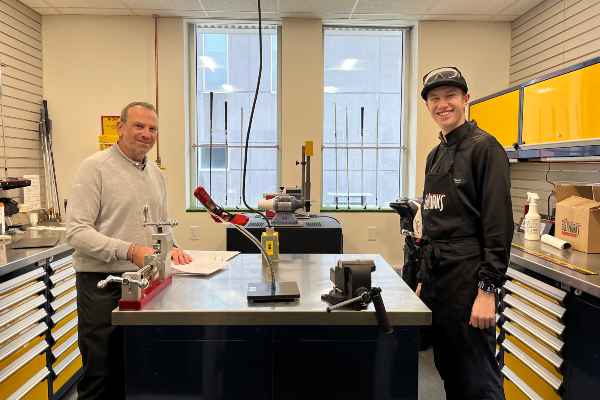 A student and faculty member in the Golf Lab workshop