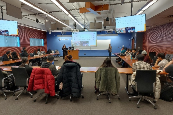 professionals in a board room listening to a presentation