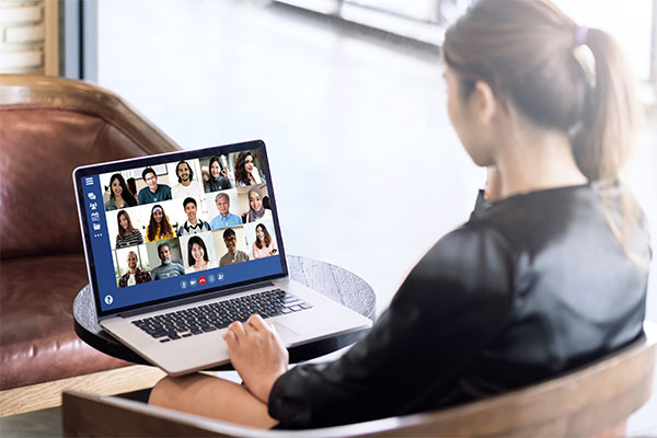 Back view of young asian business woman work remotely at home video conference remote call to corporate group.