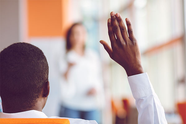 African american Business people Raising there Hand Up at a Conference to answer a question