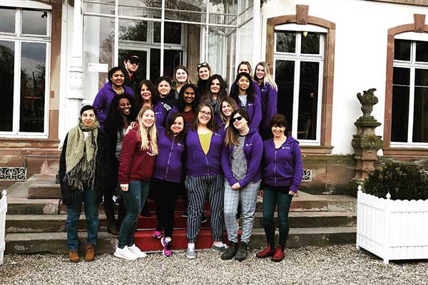 Students and Humber faculty posing for a picture on the steps of a building
