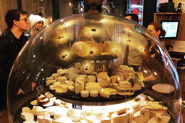 Close up of pastries under a glass dome
