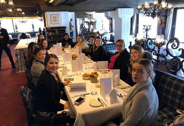 Students seated around a table in a restaurant
