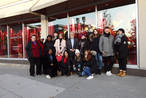 Kim Rich, Fashion Arts and Business faculty and James Cullin, Longo Faculty of Business Associate Dean along with Dominique Martin are shown here with Fashion Arts and Business Coop students in front of the CF window display