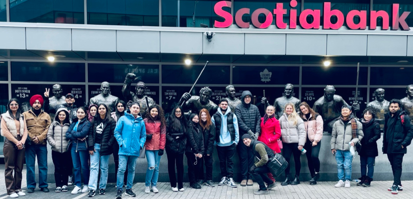 a group of tourism students standing in front of the Scotia Bank Arena