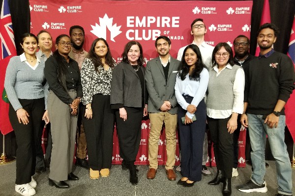 Business Management students standing in a group and smiling