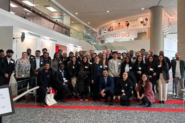 A group of Insurance Management students taking a photo inside of  the head office of Intact Financial Corporation in Toronto  