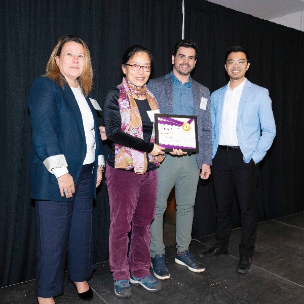 Bei Yong holding her Longo CfE award on stage