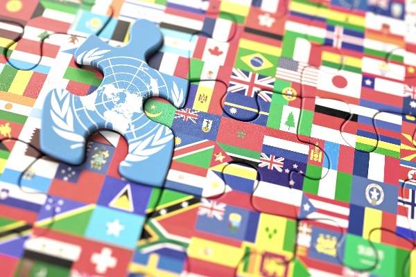 Concept puzzle with several flags of the world and United Nations in highlighted piece.