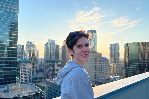 Carlyle Fitzpatrick standing on the rooftop of a building in the city