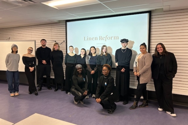 Fashion students standing in front of a projector