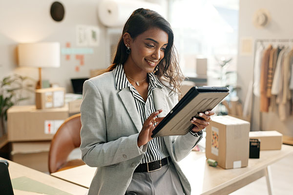 woman in business suit using a tablet in an office setting