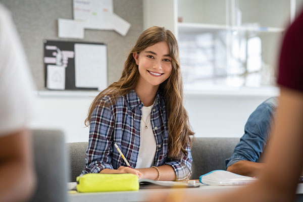 smiling college student working at a desk