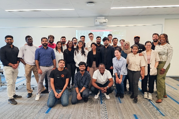 Business Management students standing in a group and smiling