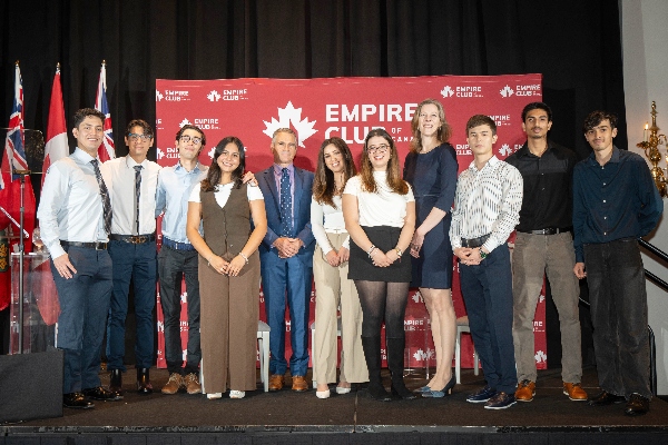 A group of International Business students on stage at the Empire Club with Pierre-Pascal Gendron, Professor & Program Coordinator 